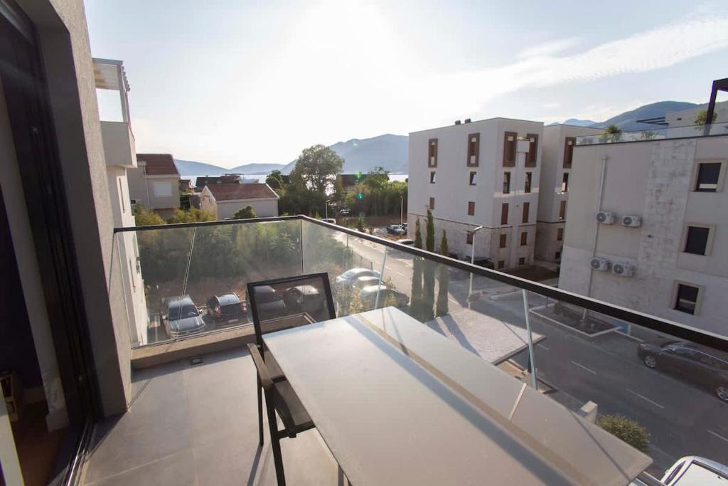 a balcony with a table and chairs on a building at Elefante 10 - Donja Lastva in Donja Lastva