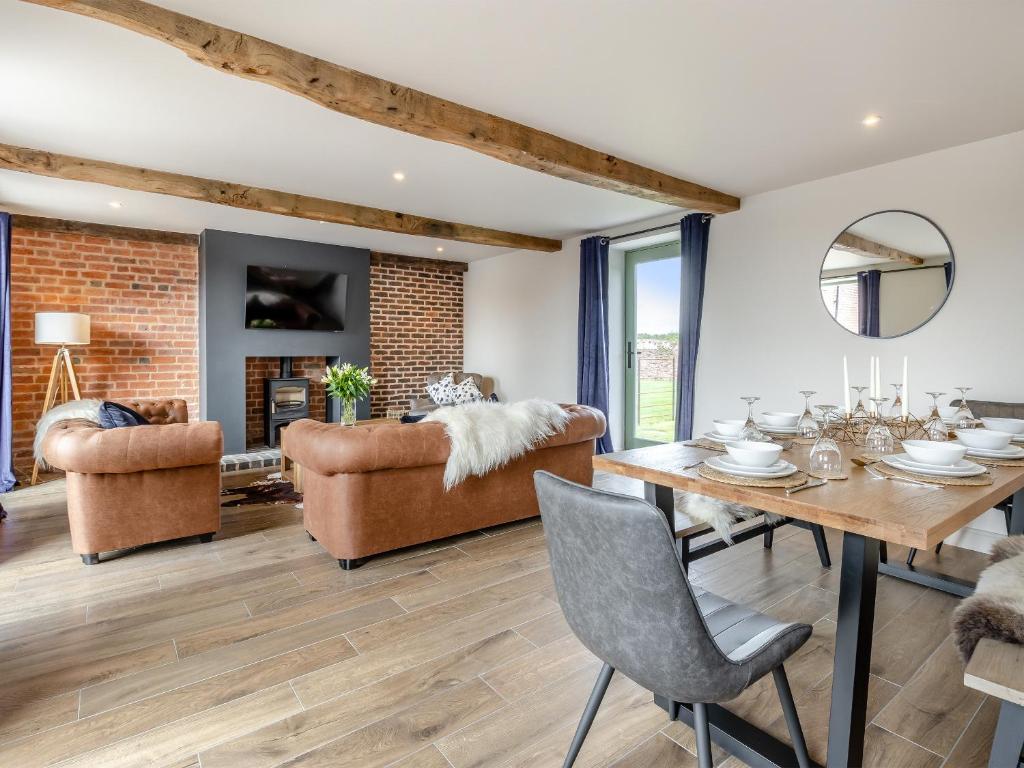 a living room with a dining room table and chairs at The Dairy - Uk44130 in Baystonhill