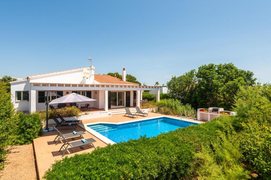 a villa with a swimming pool and a house at Villa Casa Nova by 3VILLAS in Sant Lluis