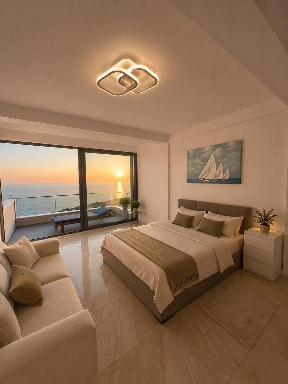 a bedroom with a large bed and a couch at Vila Maxim in Marovići