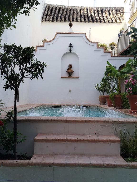a swimming pool in a house with a staircase at Casa Palacio Domus Astigi in Écija