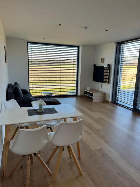 a living room with a table and chairs and a couch at Apartment Naturblick in Strem