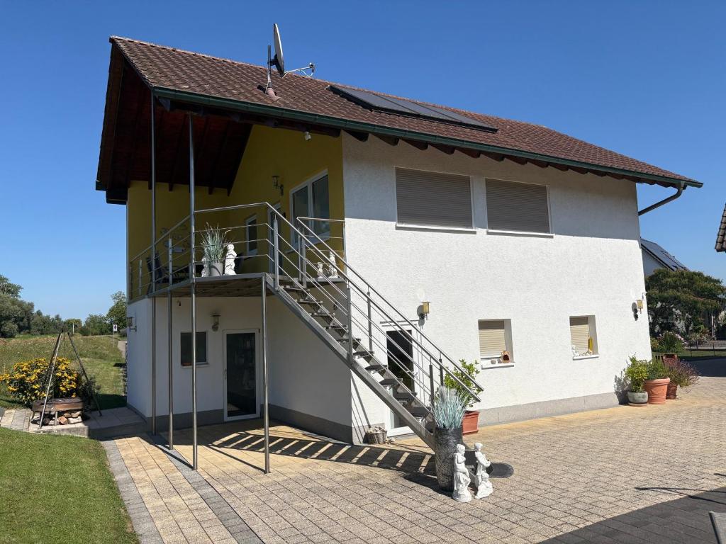 a house with a staircase on the side of it at Gästesuite mit Sauna in Kehl am Rhein