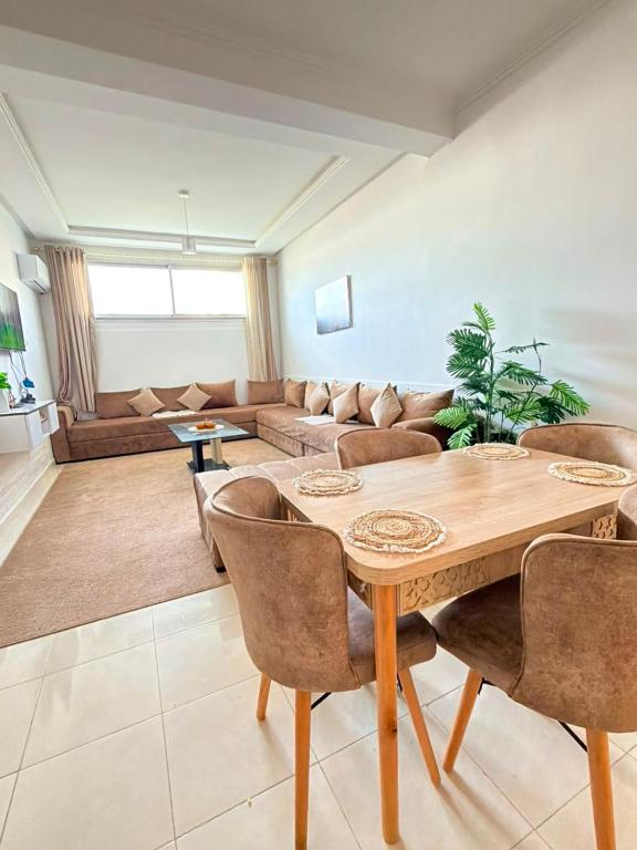 a living room with a wooden table and a couch at Sea et sun appartement in Tangier