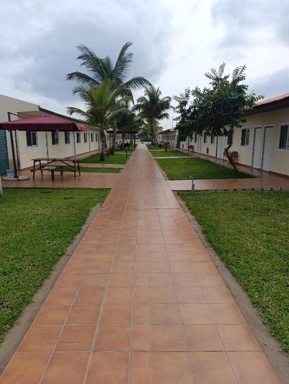 a walkway in a park with palm trees and buildings at Casa Erica in Soyo