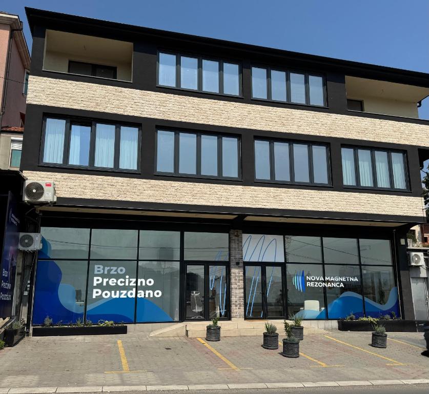 a store front of a building with windows at Mecks apartmani in Novi Pazar