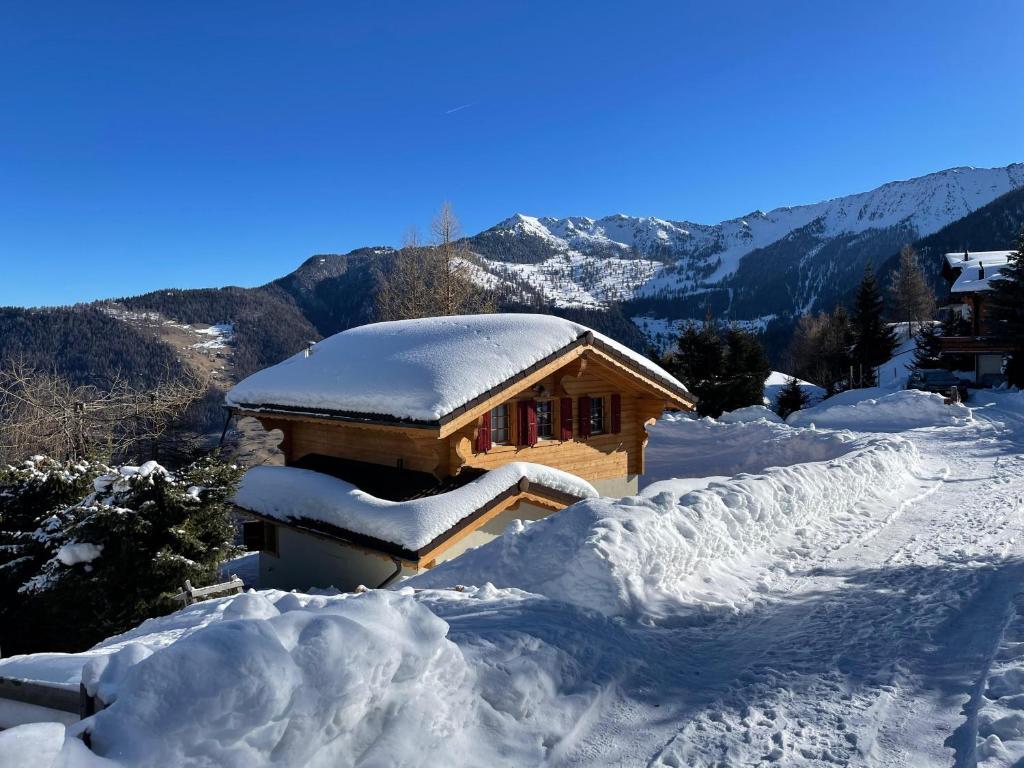 a cabin covered in snow on a mountain at Chalet Brunello in La Tzoumaz