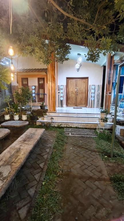 a room with benches and a building with at Bromo Jay House Homestay I in Sukapura