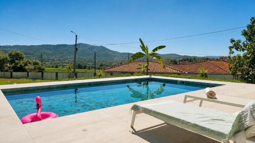 a swimming pool with a pink flamingo in a house at Villa Madalena in Coucieiro