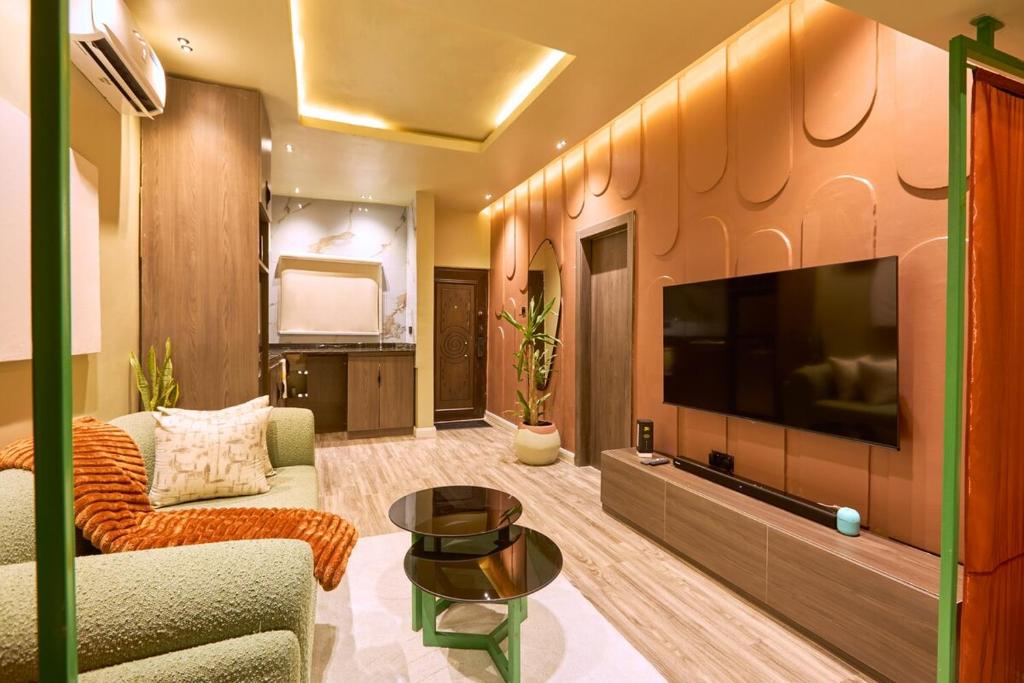 a living room with a large flat screen tv at The Chevron House in Ikuata
