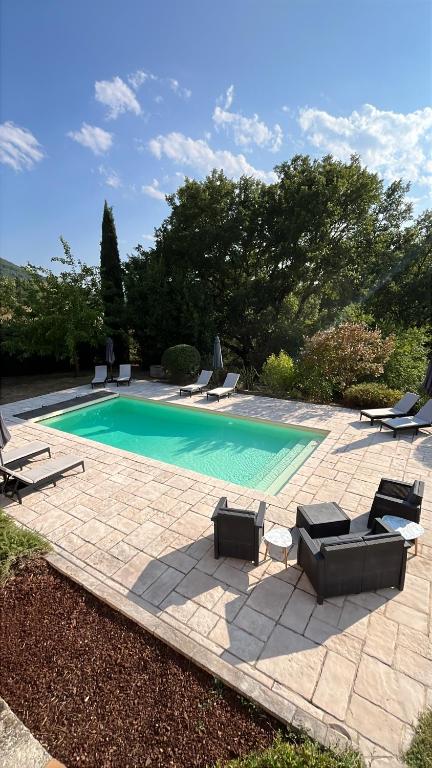 a swimming pool with lounge chairs and a swimming pool at L'Échappée Cévenole in Gagnières