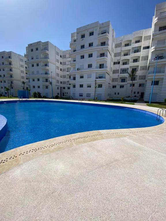 an empty swimming pool in front of a building at Chez Iceyy in Tangier