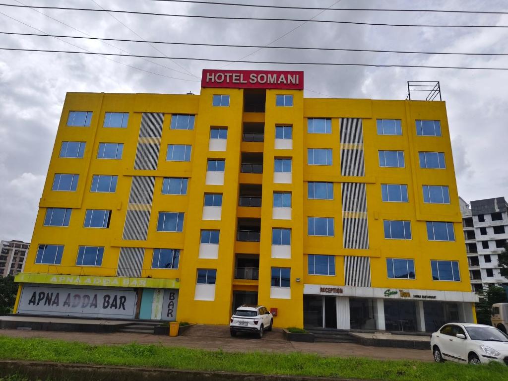a yellow hotel with a sign on top of it at The Moon Hotel Panvel in Āpta