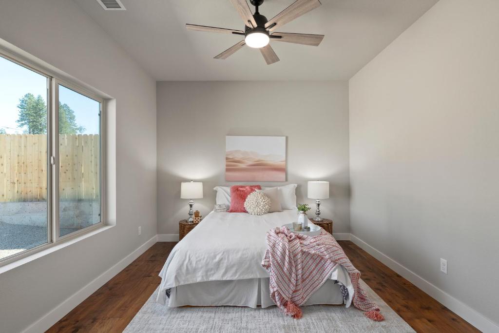 a bedroom with a bed and a ceiling fan at Gonzolez Apartments in Zamboanga