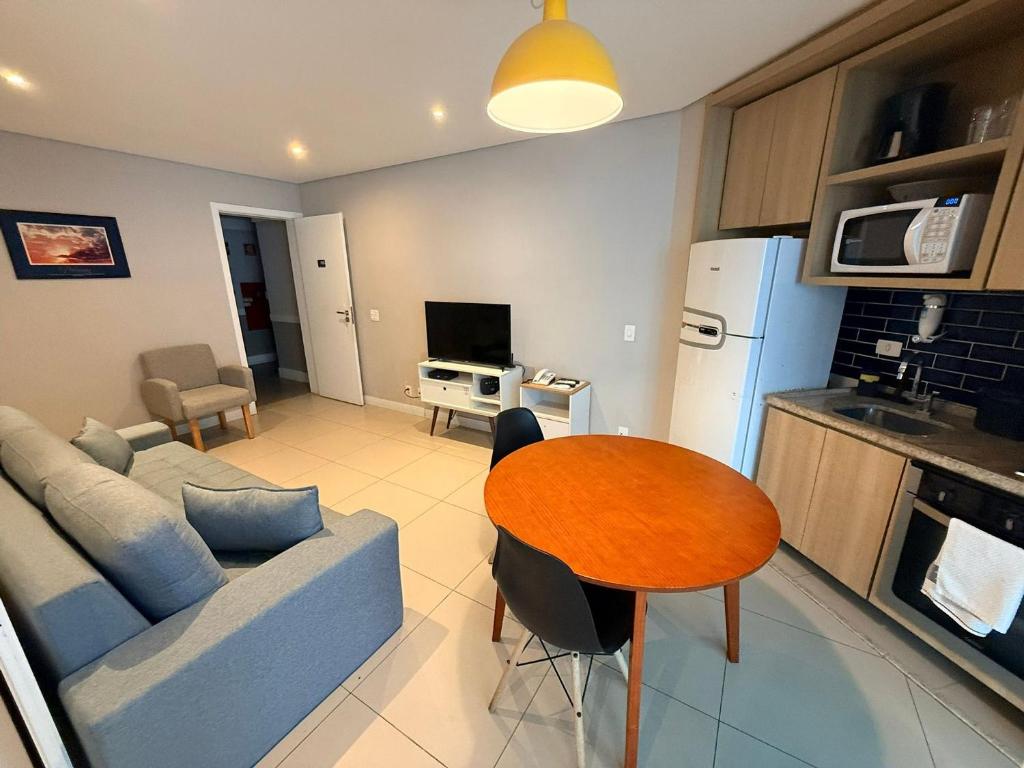 a living room with a couch and a table at Unique (Ex-Estanconfor) veja o mar do apto 703 in Santos