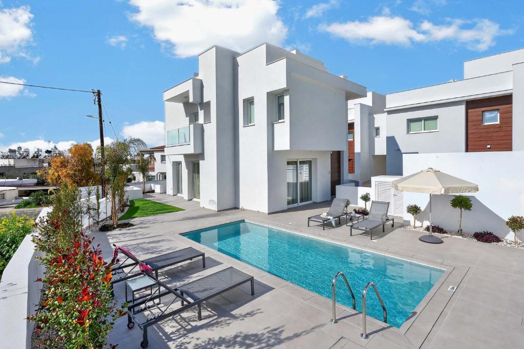 a villa with a swimming pool and a house at Sun & Moon Luxury - Celeste Villa in Ayia Napa