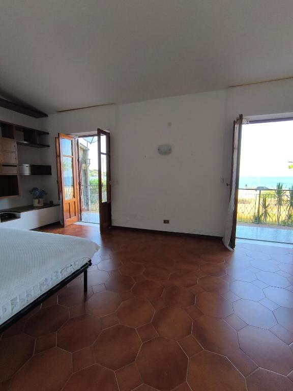 a large bedroom with a bed and a large window at Villa Sunrise in Casteldaccia