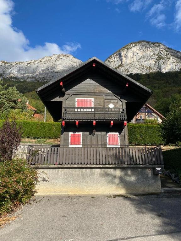 a house sitting on a bench in front of a mountain at Le Mazot in Veyrier-du-Lac