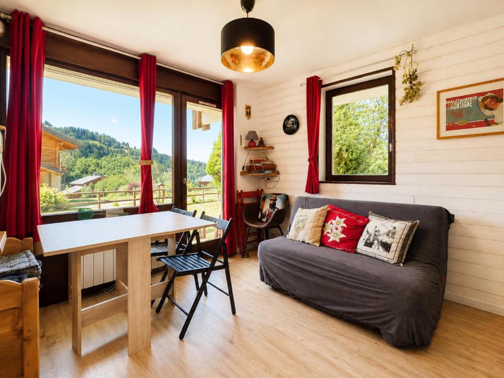 a living room with a couch and a table at Studio charmant pour 4 pers avec parking à Notre-Dame-de-Bellecombe - FR-1-505-49 in Notre-Dame-de-Bellecombe
