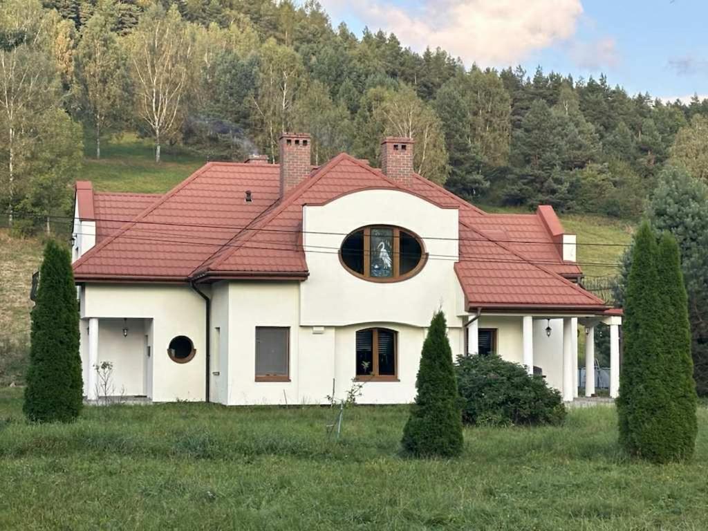 a large white house with a red roof at Guest house in Wojtkowa