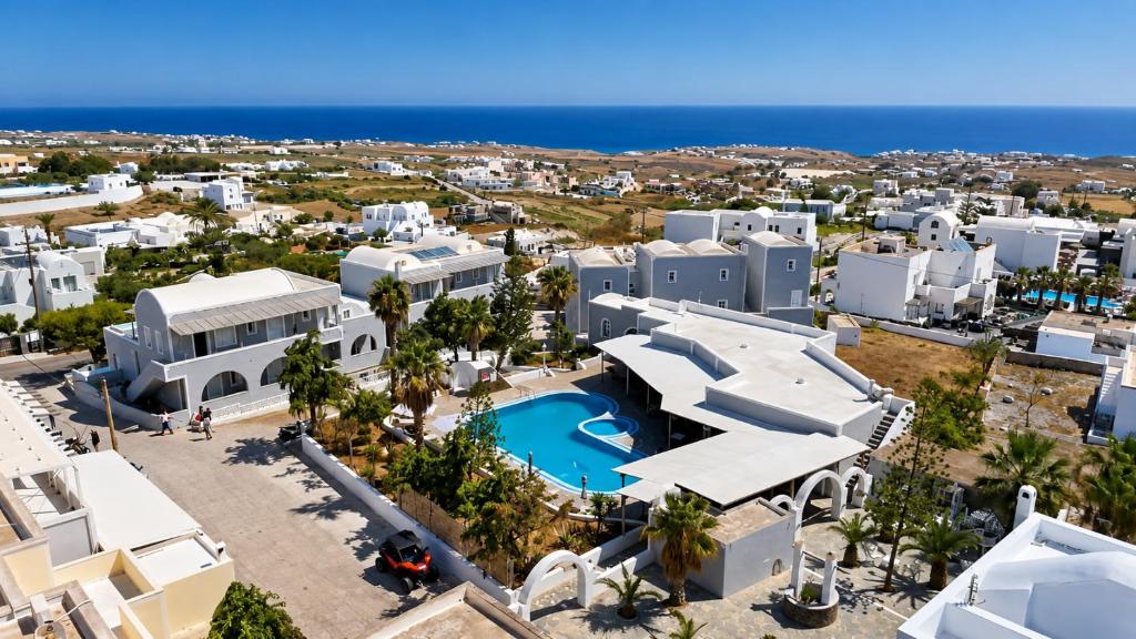 an aerial view of a resort with a swimming pool at Maistros Village Santorini - Anamar Collection in Karterados