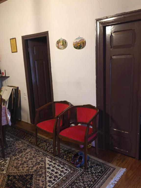 a room with two chairs and a door at Ξενώνας Το Πάλαι Ποτέ in Polydrossos