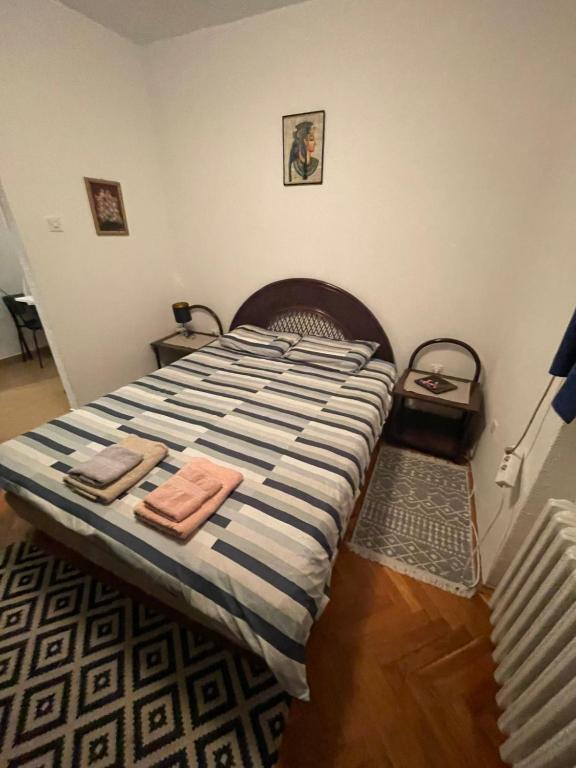a bedroom with a bed with two towels on it at Аpartman CACA in Pančevo