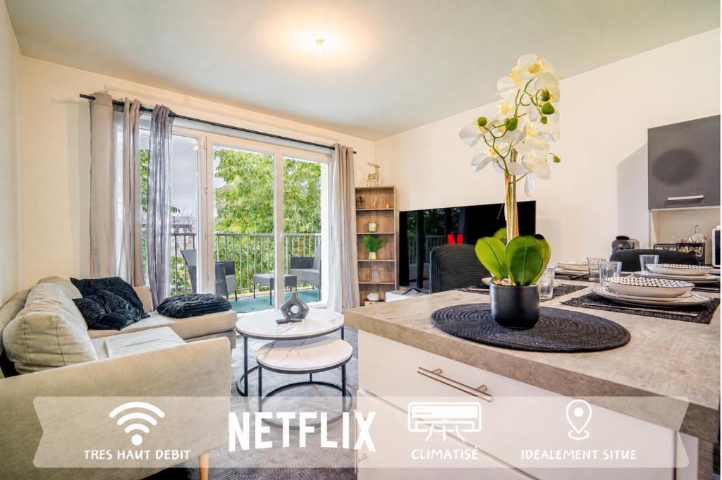 a kitchen and living room with a large window at Appart Standing in Trappes