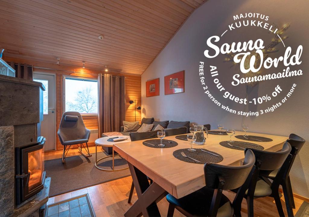 a living room with a table and chairs and a couch at Kuukkeli Apartments Suite in Saariselka