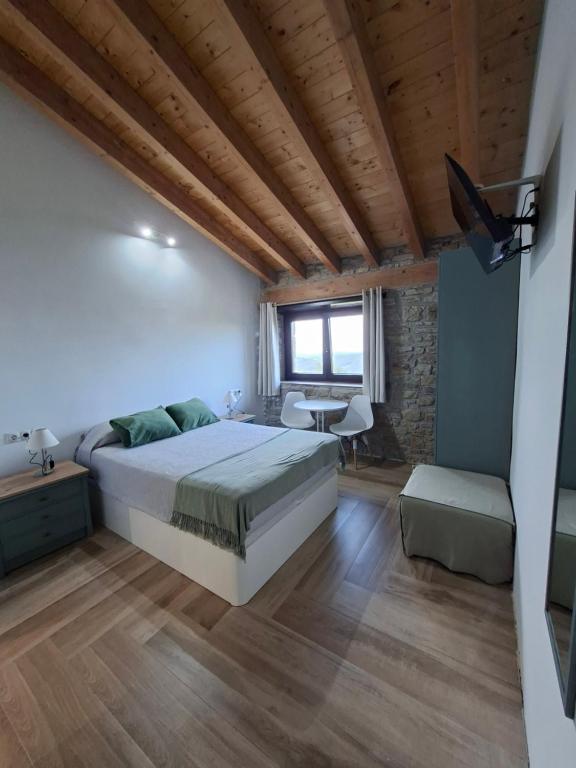 a bedroom with a large bed and a table at La Casona de Regolfo in Regolfo