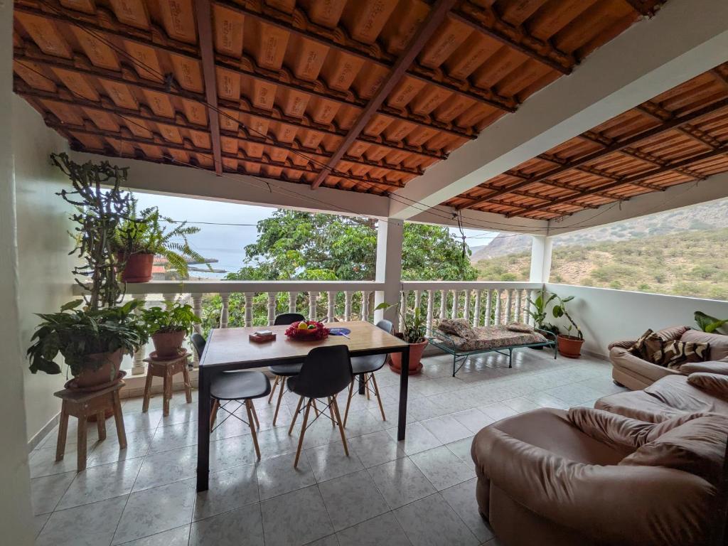 a living room with a table and chairs at Ponta Gato Residence in Tarrafal