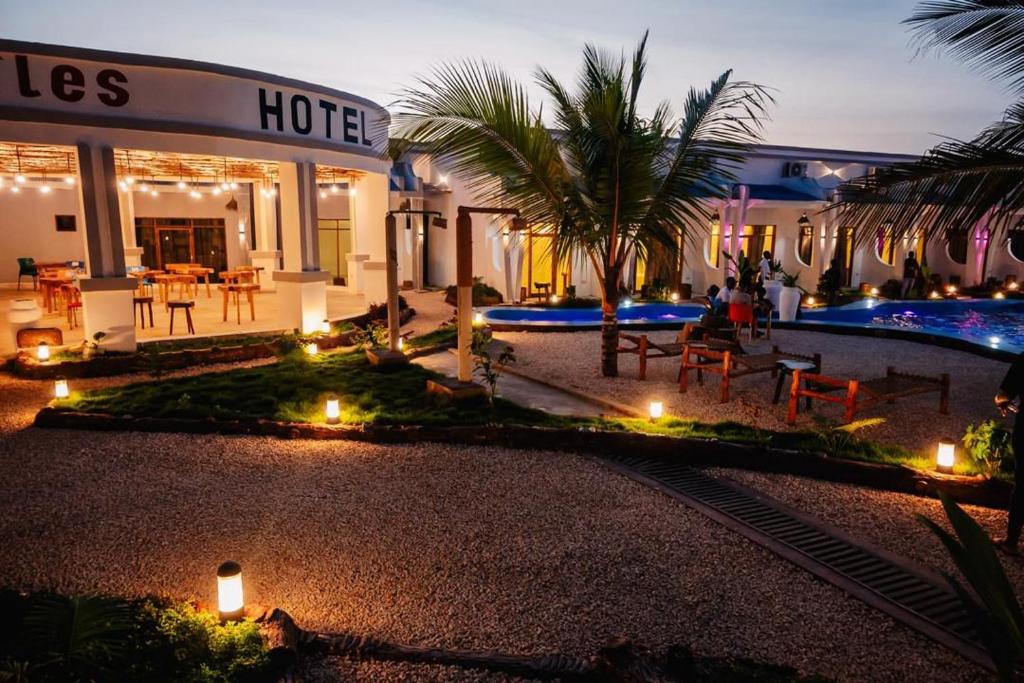 a hotel with lights in front of a building at Googles Beach Hotel Zanzibar in Zanzibar City
