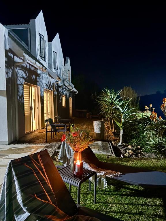 a house at night with a vase of flowers on a table at Providence in Hermanus