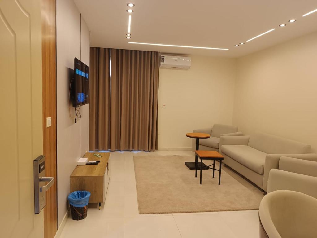 a living room with a couch and a table at Tamaya Hotel, Fifth Settlement, New Cairo in Cairo