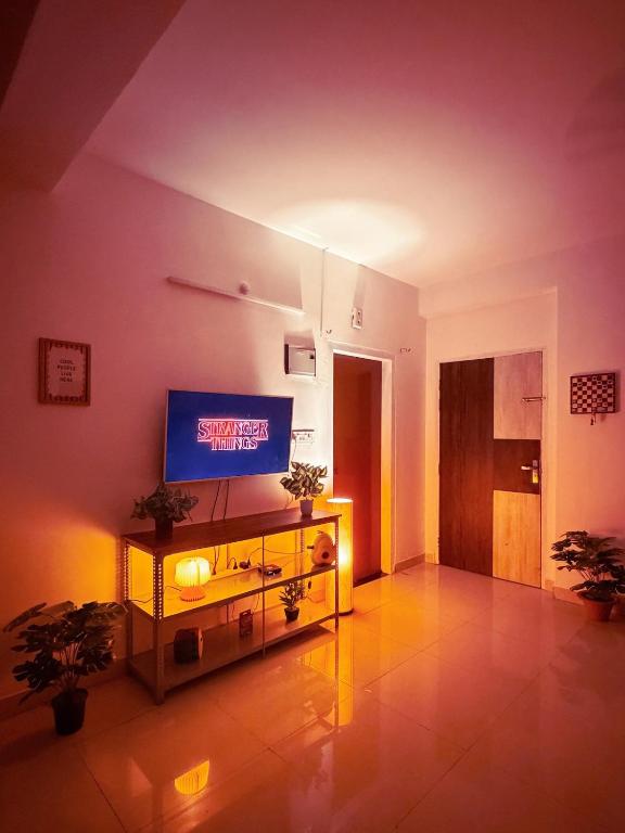 a living room with a television on a table at Eden Stay in Siliguri