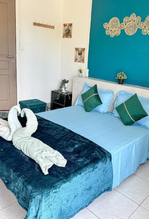 a bedroom with a bed with a towel animal on it at L'échappée verte in Chirongui