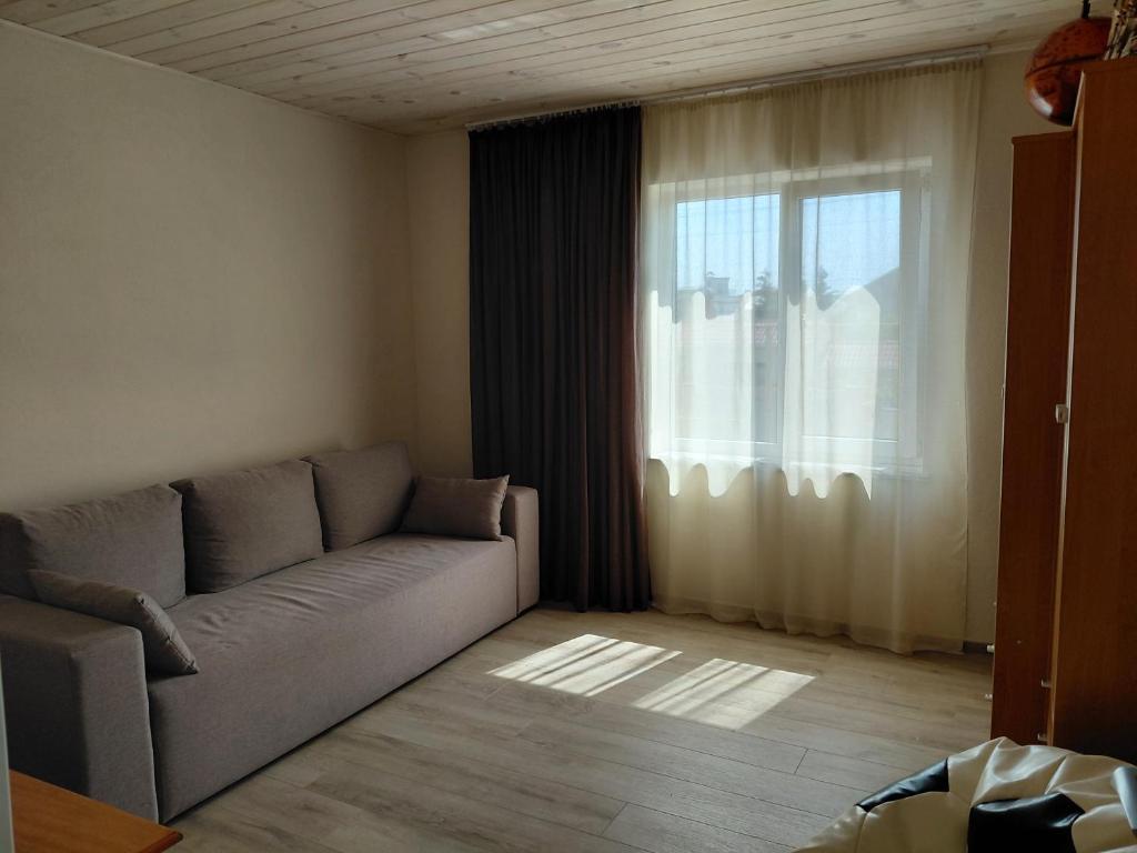a living room with a couch and a window at Уютная Дача in Zatoka