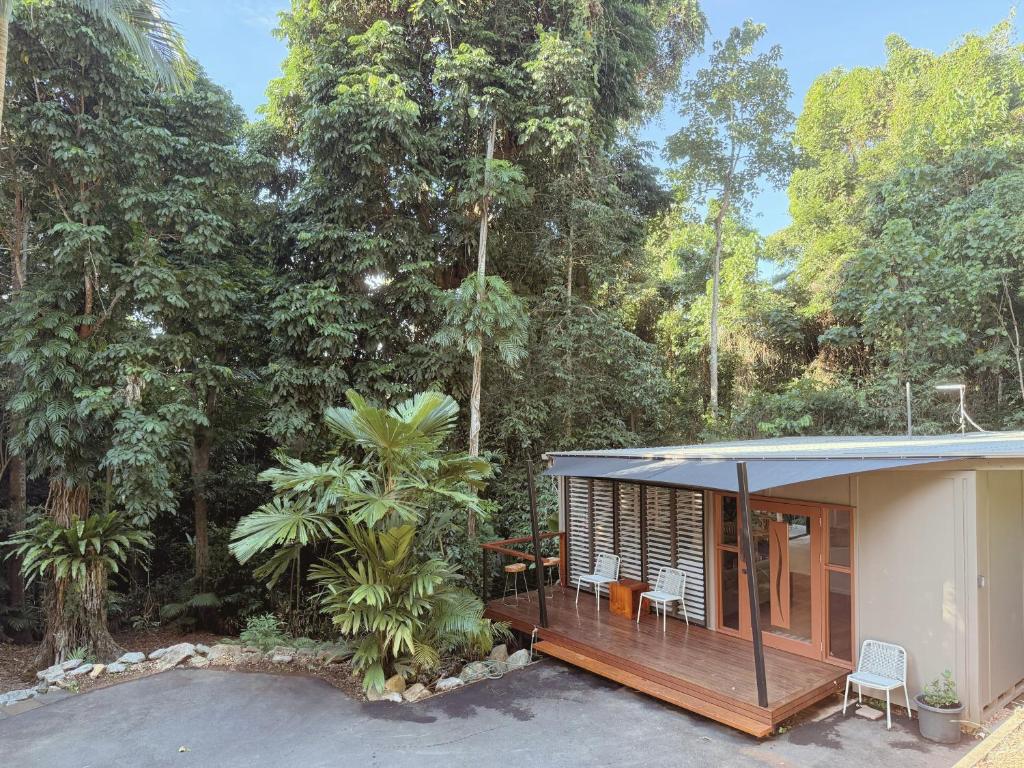 a small house in the middle of a forest at Private Rainforest Cottage - Bingil Bay in Mission Beach