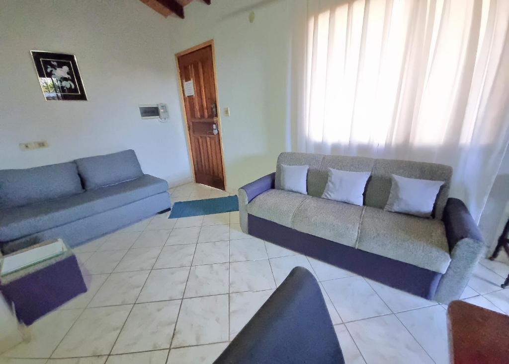 a living room with two blue couches in a room at Departamento Batti in Asunción