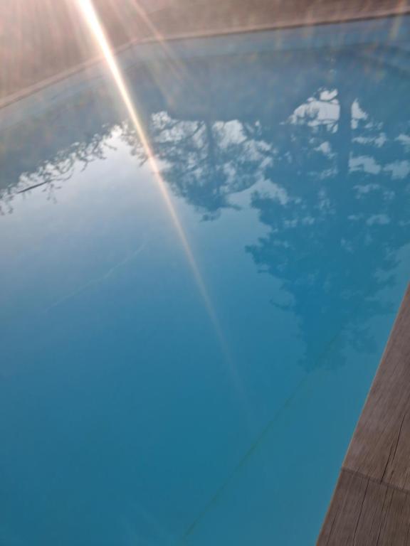 a close up of a pool with a rainbow in the water at Espace naturel in La Tour-de-Salvagny