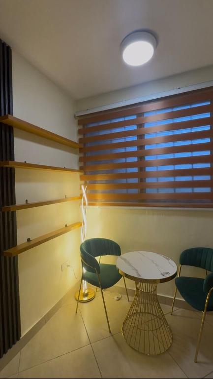 a room with a table and chairs and a window at Gods Grace homes in Duasi