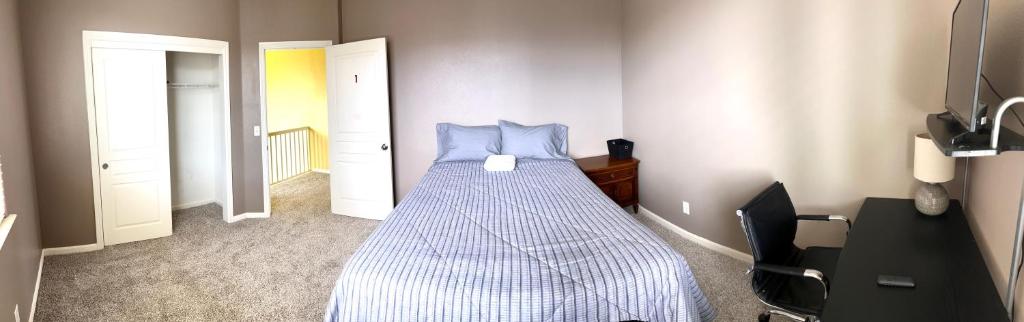 a bedroom with a bed with a blue comforter at la paz room 1 in Fresno