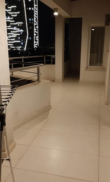 an empty room with a view of a city at night at ORAN App in Dherinia
