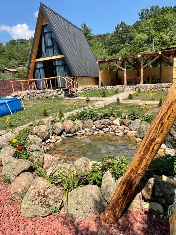 a house with a pond in front of it at Hayrapet Asatryan in Arzakan