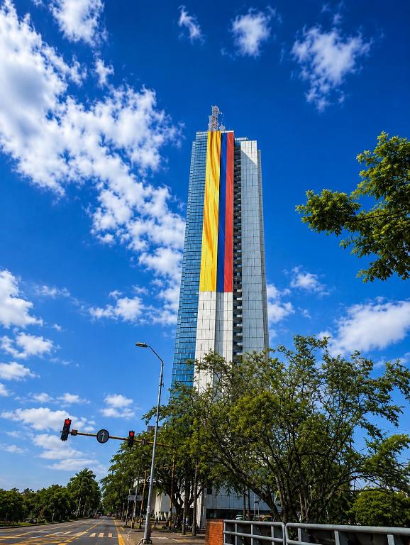 a tall building with a rainbow flag on it at Apartamentos - Torre de Cali in Cali