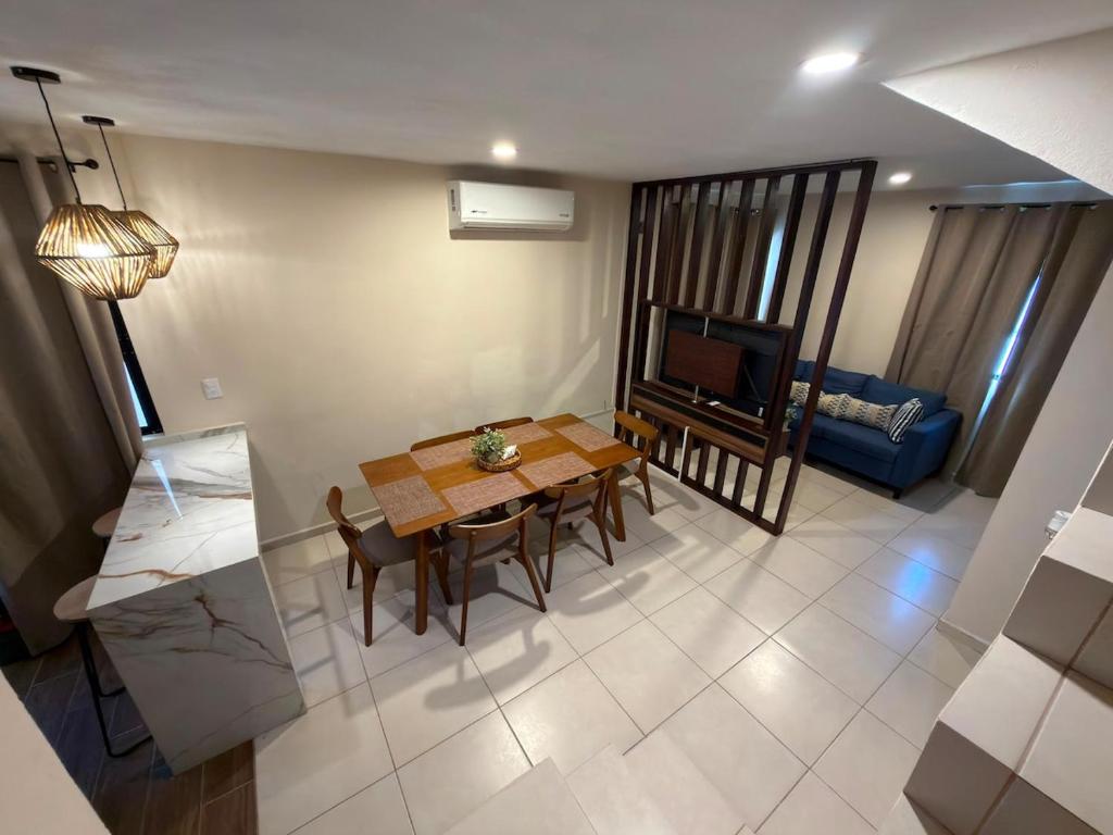 a living room with a dining room table and a television at Casa Cielo del Mar in Ciudad Madero