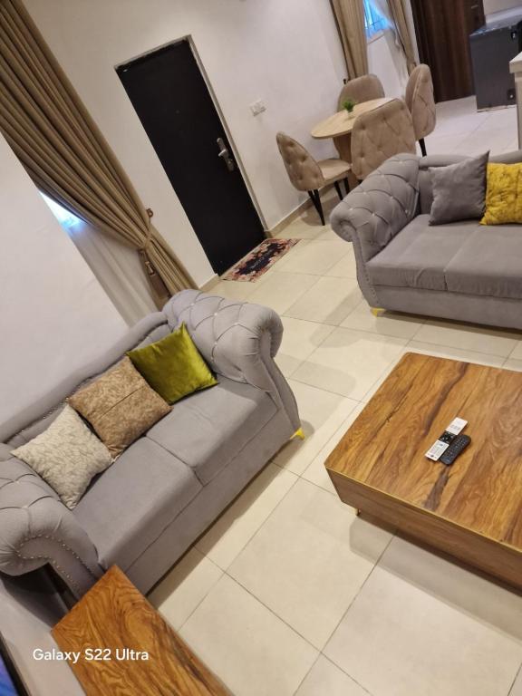a living room with two couches and a coffee table at NestNov in Aguda