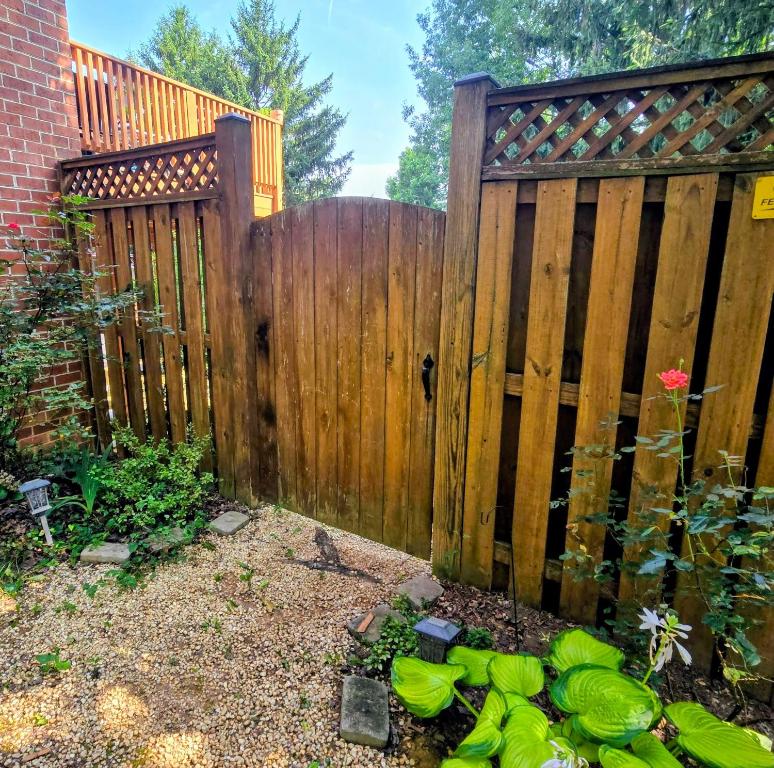 a wooden fence with a gate in a garden at MALE Only Shared Basement in Frederick