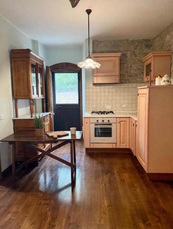 a kitchen with a table and a stove top oven at Casale Santilli in Agnone