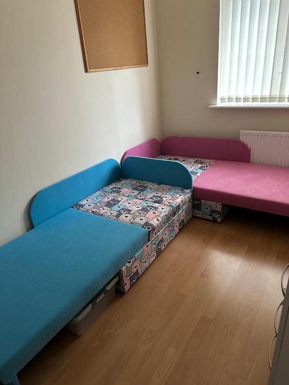 a room with two futon beds in a room at Gudere house in Enfield Lock